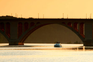 key bridge at sunset with boat
