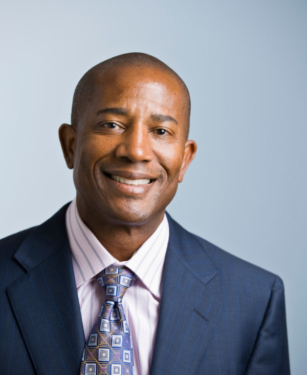 Middle Aged African American male headshot in a suit and tie