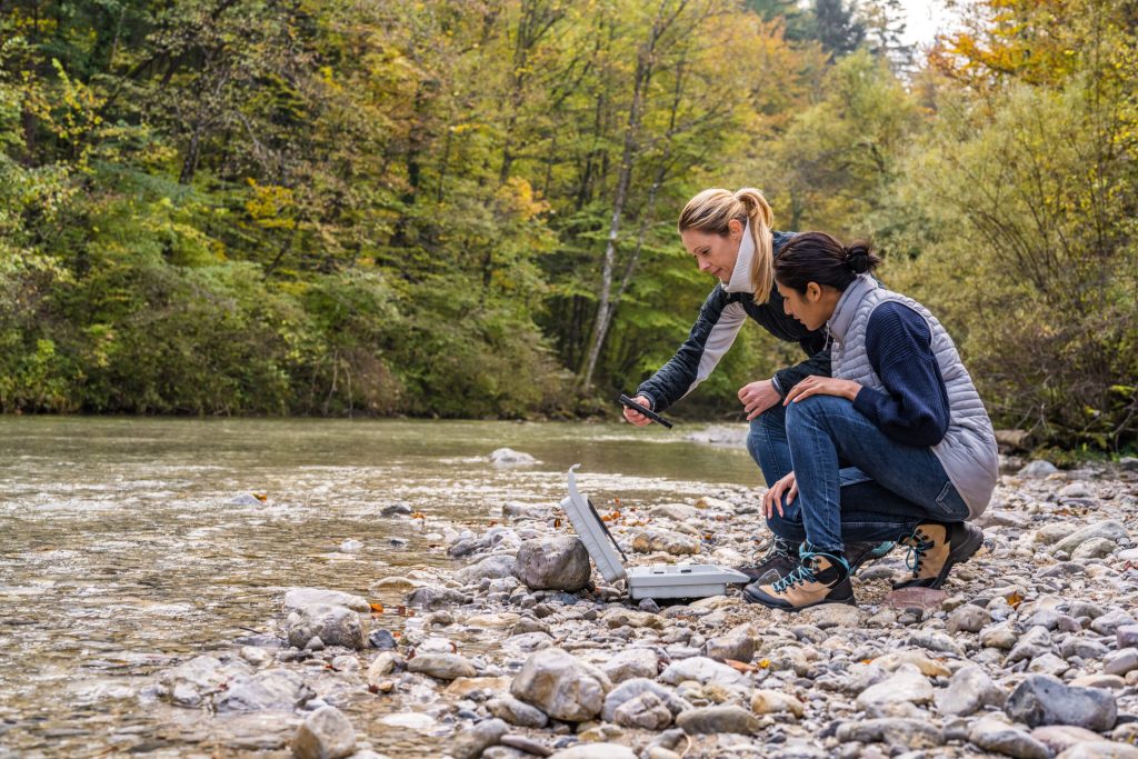 two female biologists at stream